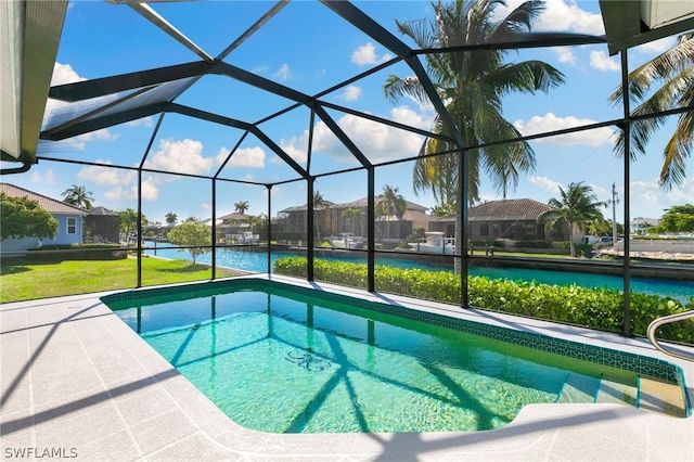 view of swimming pool with a water view, glass enclosure, and a lawn