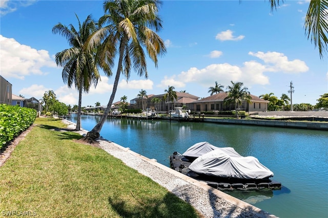 view of dock featuring a yard and a water view