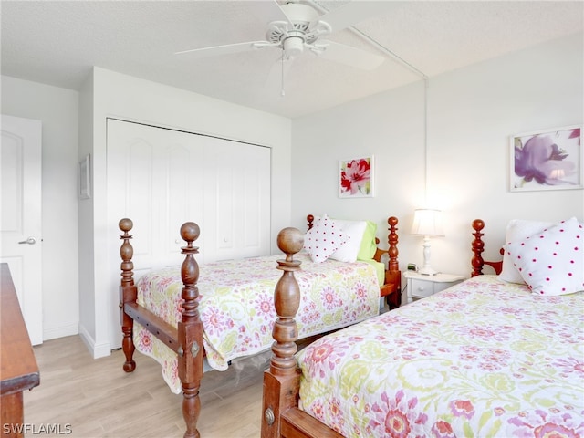 bedroom with a closet, ceiling fan, and light wood-type flooring