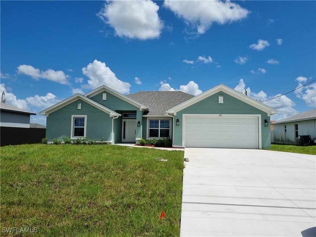 view of front of house with a front yard and a garage