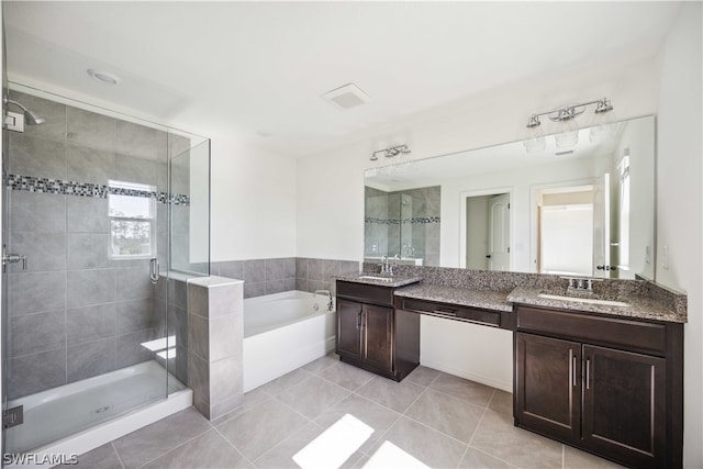 bathroom featuring vanity, tile patterned flooring, and plus walk in shower