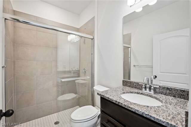 bathroom with toilet, an enclosed shower, and vanity