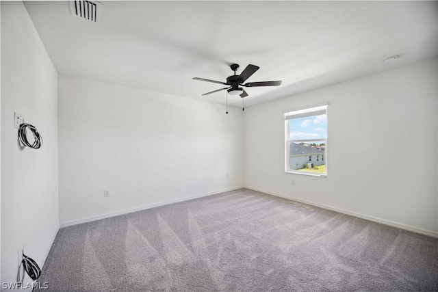 carpeted empty room featuring ceiling fan