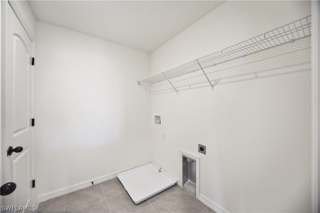 laundry area with light tile patterned floors, hookup for a washing machine, and hookup for an electric dryer