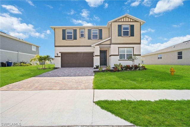 view of front of property with a garage and a front lawn