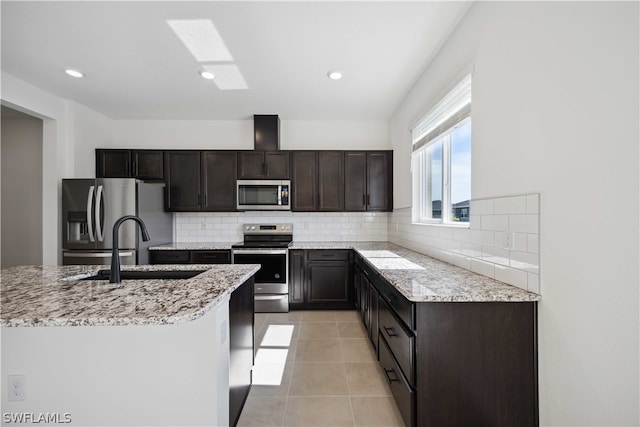 kitchen featuring sink, backsplash, appliances with stainless steel finishes, and light tile patterned flooring