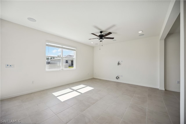 tiled empty room with ceiling fan