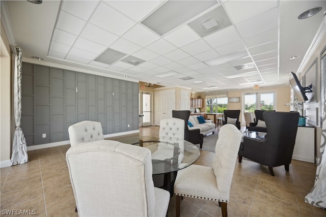 dining space with light tile patterned floors and a paneled ceiling