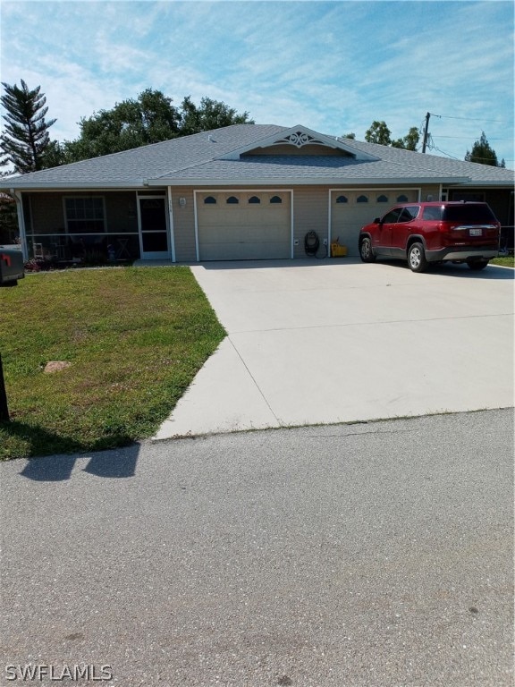 view of front of property featuring a garage and a front lawn