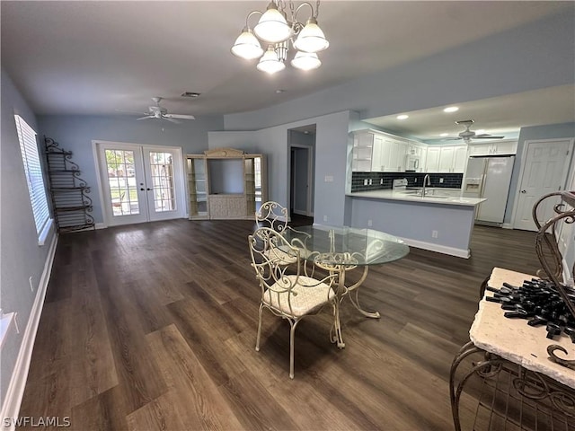 dining space featuring french doors, dark wood-type flooring, visible vents, and baseboards