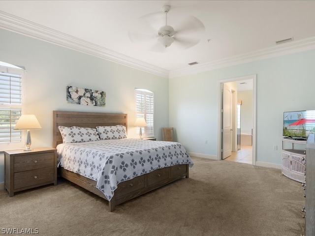 bedroom featuring light carpet, ensuite bath, ceiling fan, and ornamental molding