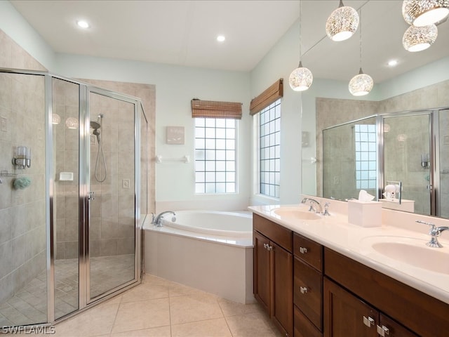 bathroom featuring shower with separate bathtub, oversized vanity, and dual sinks