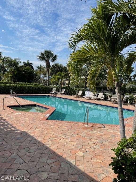 view of swimming pool with a community hot tub