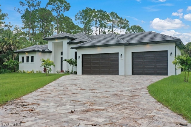 view of front of house with a front yard and a garage