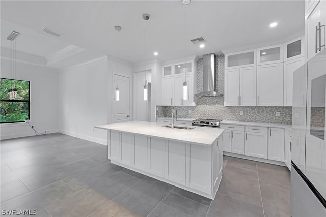 kitchen with sink, electric range, hanging light fixtures, white cabinets, and wall chimney exhaust hood