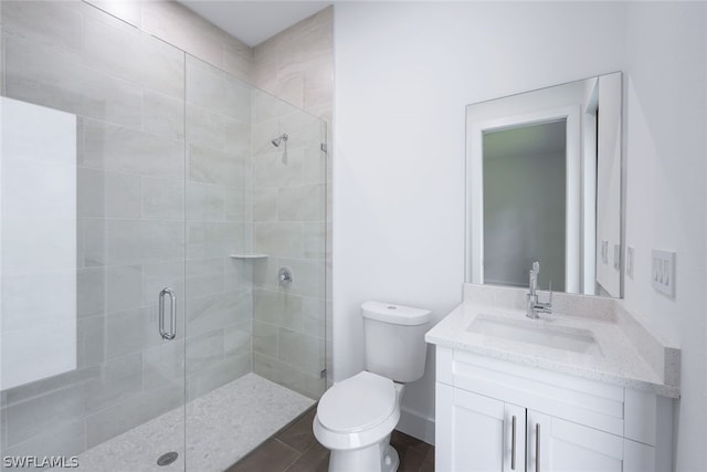 bathroom with an enclosed shower, oversized vanity, and toilet