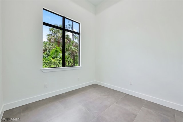 spare room with light tile floors