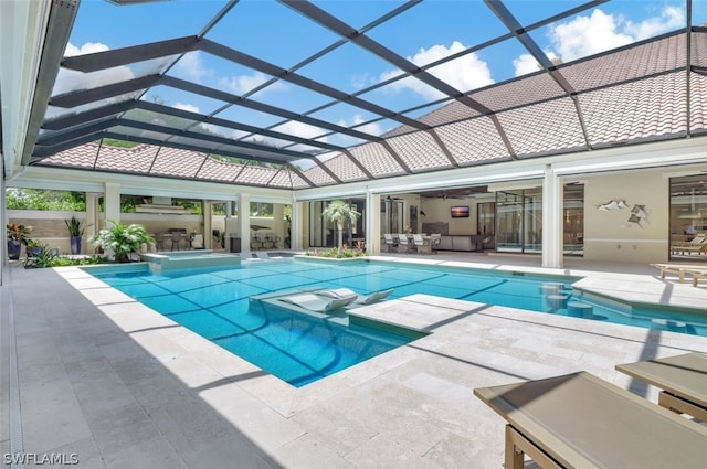 view of swimming pool with glass enclosure and a patio area