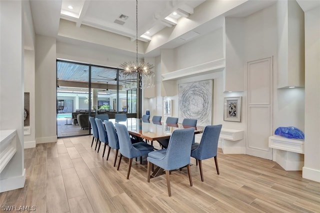 dining room featuring coffered ceiling, a chandelier, light hardwood / wood-style floors, and a wealth of natural light