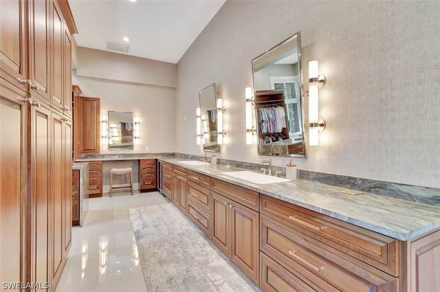 bathroom featuring tile flooring, oversized vanity, and dual sinks