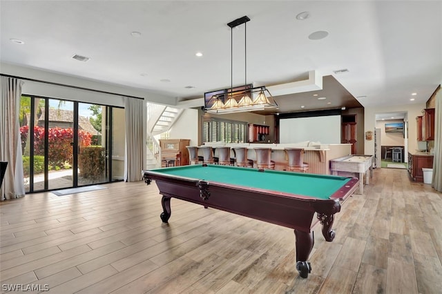 recreation room with light hardwood / wood-style flooring, bar area, and pool table