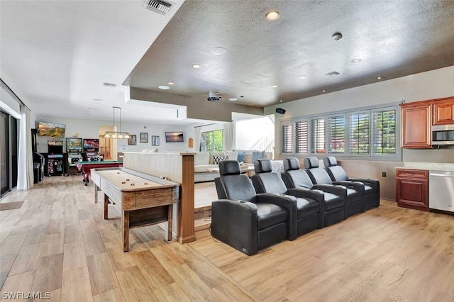 living room featuring billiards, a textured ceiling, and light wood-type flooring