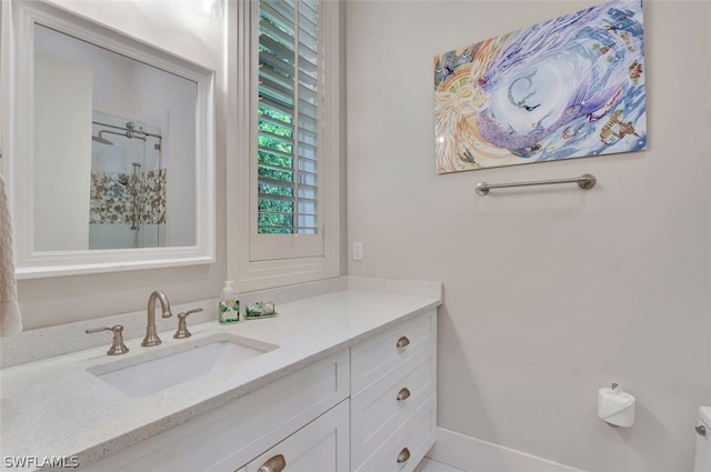 bathroom featuring large vanity and toilet