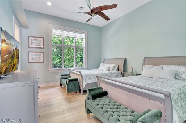 bedroom with ceiling fan and light wood-type flooring