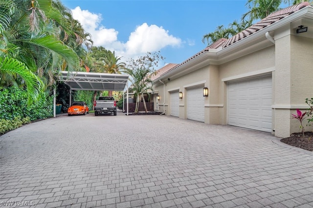 exterior space with a carport and a garage