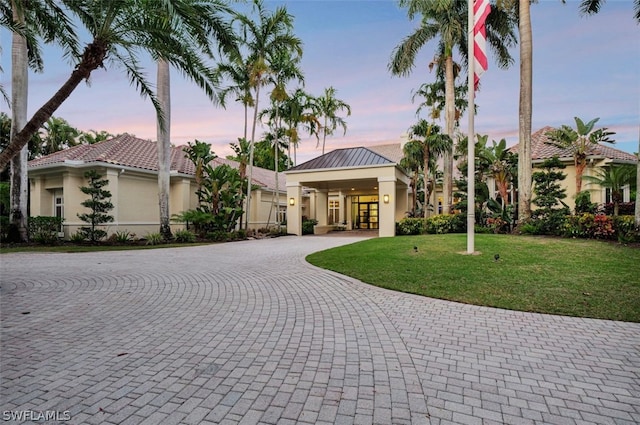 mediterranean / spanish-style home featuring a yard