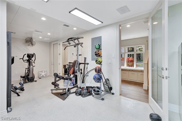 workout area with light hardwood / wood-style flooring