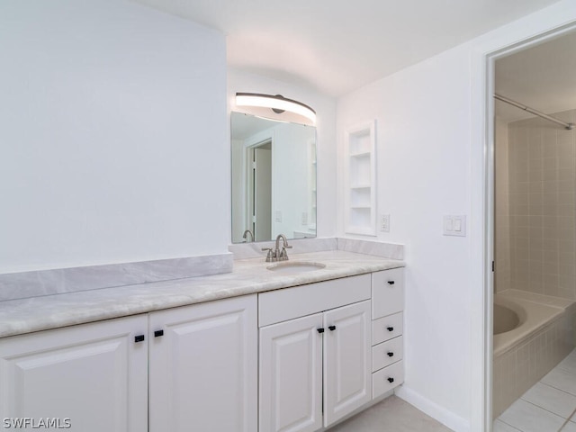 bathroom with vanity, tile patterned flooring, and tiled shower / bath combo