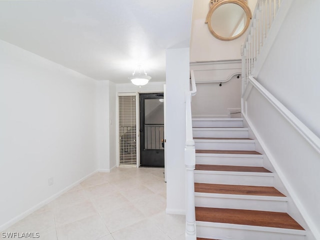 staircase with light tile patterned floors