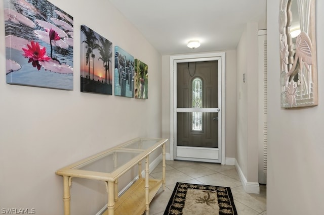 doorway to outside featuring light tile patterned flooring