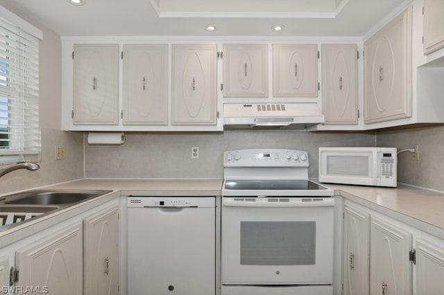 kitchen with white appliances, white cabinetry, and sink