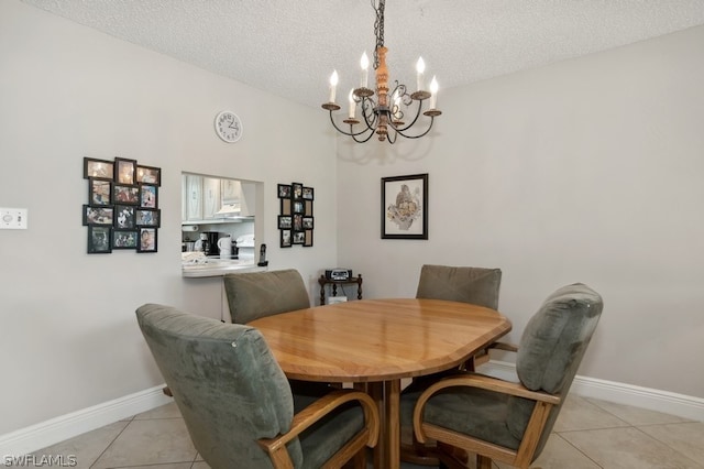 dining room with a textured ceiling, light tile patterned floors, and a notable chandelier