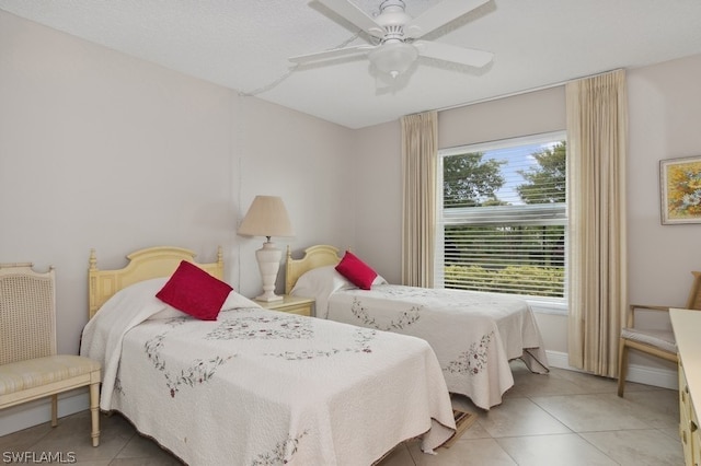 tiled bedroom featuring ceiling fan