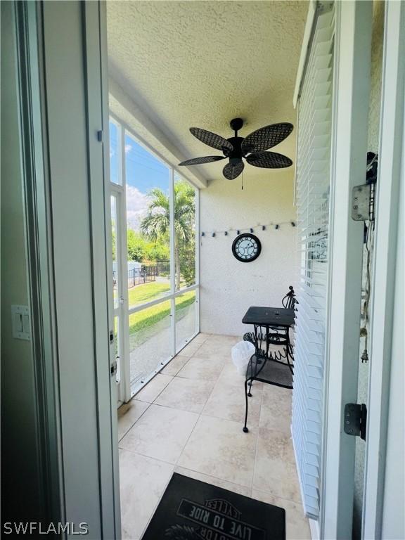 sunroom / solarium featuring ceiling fan