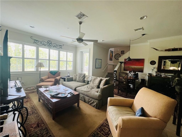 living room with ceiling fan, ornamental molding, and visible vents