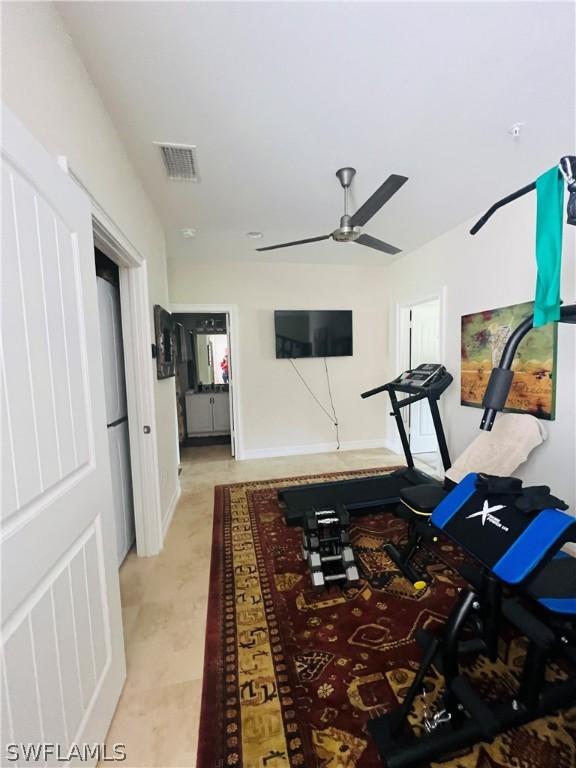 workout room with a ceiling fan and visible vents