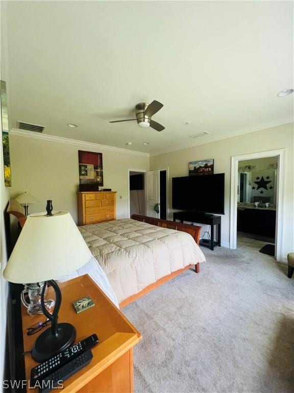 carpeted bedroom with ceiling fan, visible vents, and crown molding