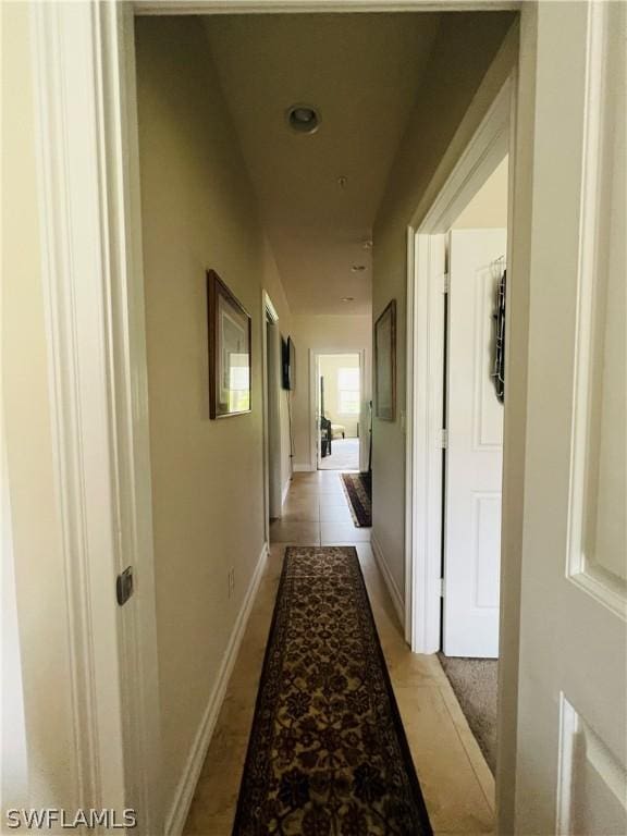 hall featuring baseboards