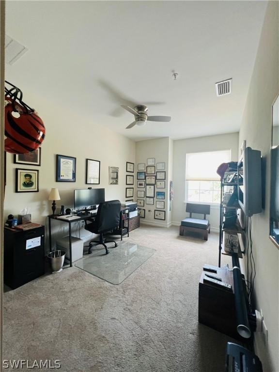 home office featuring a ceiling fan, baseboards, visible vents, and carpet flooring