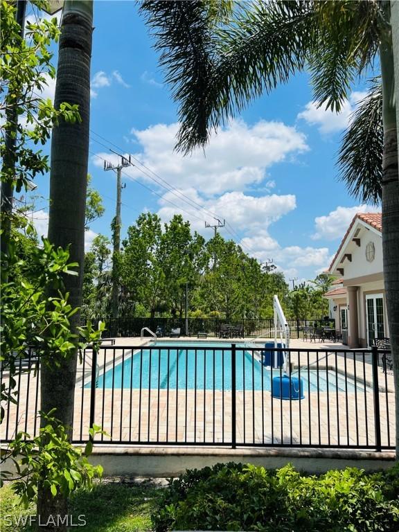 pool featuring fence, a patio, and french doors