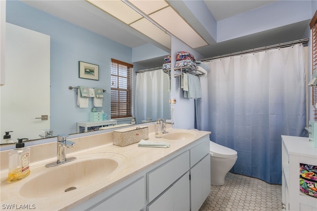 bathroom featuring vanity, toilet, and tile patterned floors