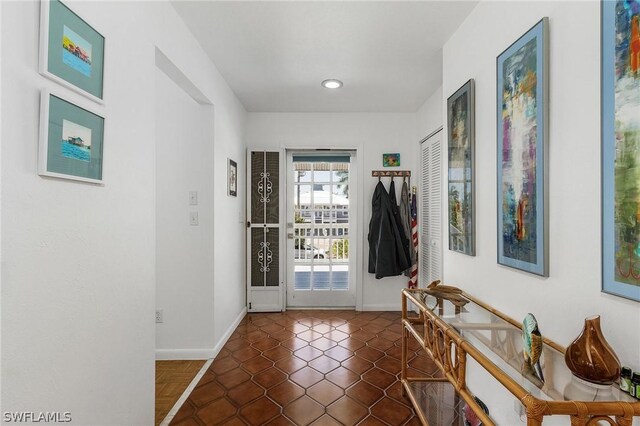 doorway featuring dark tile patterned floors