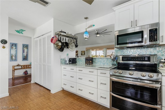 kitchen featuring light stone countertops, stainless steel appliances, light parquet flooring, ceiling fan, and white cabinets