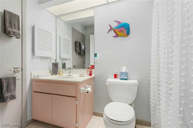 bathroom with tile patterned flooring, vanity, toilet, and a shower with curtain