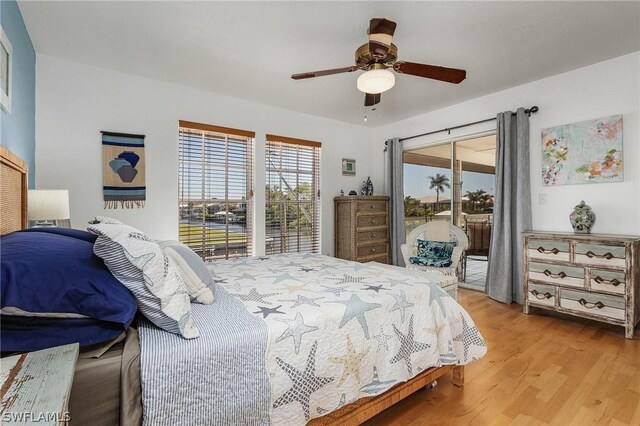 bedroom with access to outside, light hardwood / wood-style flooring, and ceiling fan