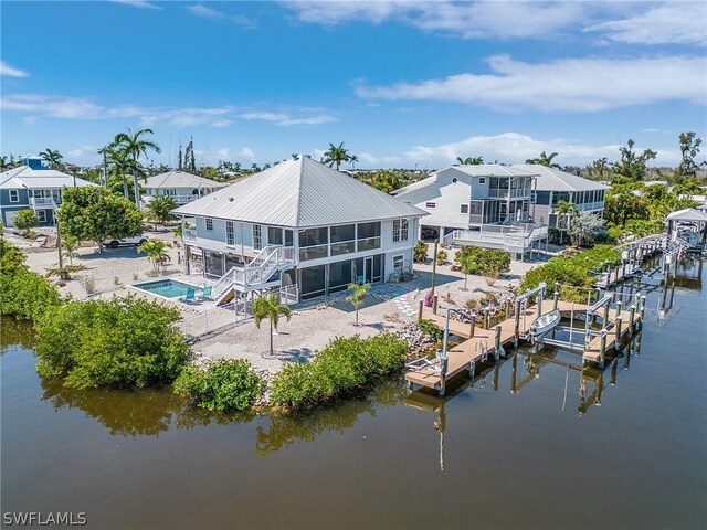 back of house with a patio area and a water view